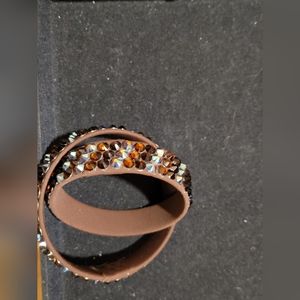 Two jeweled bracelets in brown and black